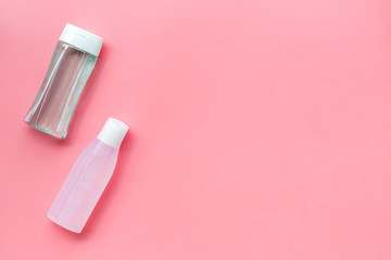 facial tonic and lotion for face care on pink background top view mock up