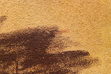 Blurred abstract background. Texture of beige painted concrete rough surface with coarse brown brush strokes. Cropped shot, horizontal, place for text, nobody. Design concept.