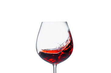 Splashing red wine in a glass on a white background