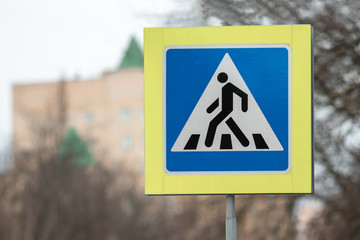 New crosswalk road sign on blue sky background.