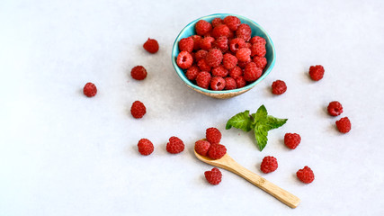 Raspberry in bowl. Raspberry on light background. Organic Raspberry. Red berry. Still life, top view with copy space
