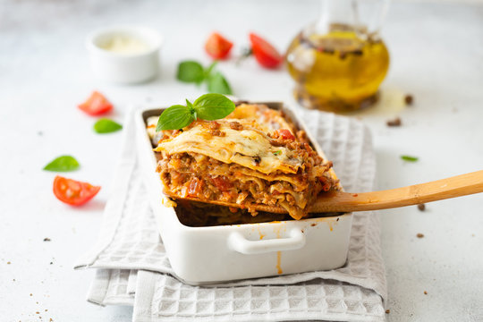 Tasty lasagne with meat, cheese on white plate