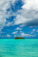 Vertical panoramic of small island with palm trees in the Indian Ocean