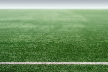 Obraz premium Green sports field with artificial grass, football field perspective.