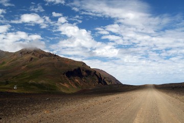 Fototapeta na wymiar Endless straight dirt road on Iceland
