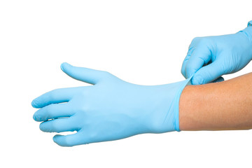 Doctor putting on protective blue gloves isolated on white background
