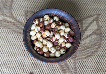 Healthy food  for background image close up hazelnuts.  Nuts texture on top view on the cup plate