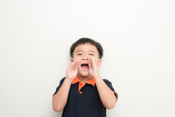 Surprised little boy. Shocked little boy keeping mouth open and touching face with hands while standing isolated on white