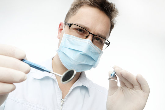 Dentist with dentistry tools isolated