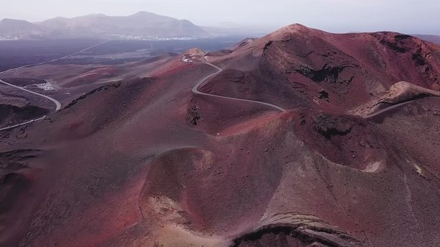 red volcanic mountains with craters  in Timanfaya national park in Lanzarote island, aerial view landscape of Canary islans, nature in Spain