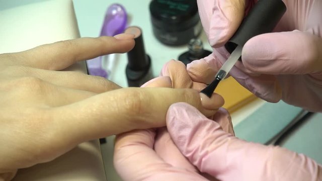 Master of manicure makes nail extensions gel