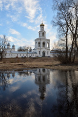 View of the Yuryevsky monastery with reflection in the water. Spring. Veliky Novgorod