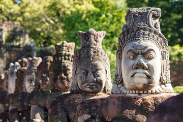 Fototapeta na wymiar Head sculptures on the bridge leading to the south gate at Angkor Thom temple complex, Siem Reap, Cambodia