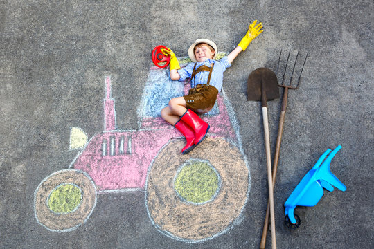 little kid boy having fun with tractor chalks picture 