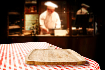 Table background of free space in restaurant interior and cook chef. 