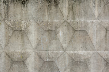 Textured of a old concrete slab. Fragment of concrete slab with a regular prismatic