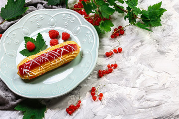 Sweet eclair with berry. french dessert Eclair. custard pastry dessert with whipped cream inside....