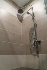 Beautiful shower with traces of droplets and lime in bathroom of porcelain stoneware. Gray shades