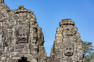 Beautiful face sculptures at the famous Bayon temple in the Angkor Thom temple complex, Siem Reap, Cambodia