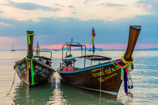 Long tail boats at sunset on Railay beach in Railay, Ao Nang, Krabi Province