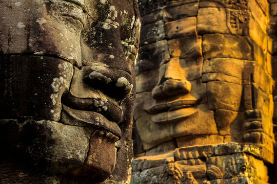 T wo of 216 smiling sandstone faces at 12th century Bayon, King Jayavarman VII's last temple in Angkor Thom, Angkor, Siem Reap, Cambodia