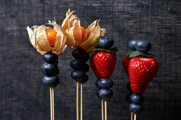 blueberries, strawberries, fly in different directions