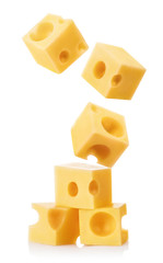 Falling cubic pieces of delicious cheese, isolated on white background