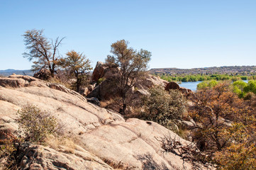 Rocks above a lake in the desert in Arizona under bright blue skies