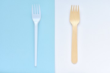 Wooden and plastic disposable forks, comparison, zero waste concept, top view.