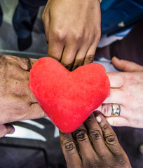 hands of all colors give their heart, altruism