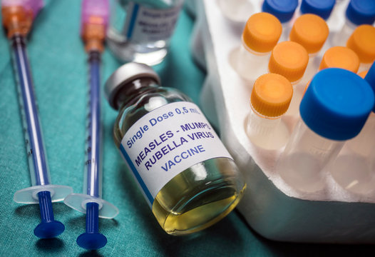 Different vials of triple viral vaccine of measles, rubella and mumps, known as MMR, conceptual image