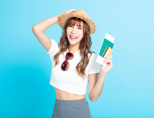 happy tourist woman in summer hat showing passport and ticket