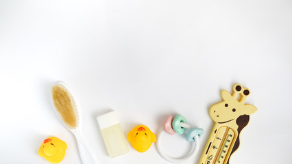 Baby bath products isolated on white background with copy space. flat lay soap bar, yellow rubber duck and liquid soap, toy