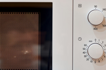 Turned on classic microwave oven. Closeup.