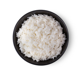 Rice in a black bowl on a white background. top view