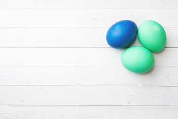 Colorful Easter eggs on white table. Copy space.
