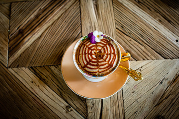 Capuccino with sweet on a Wood table