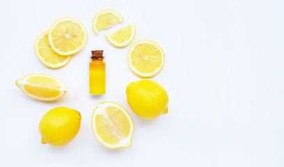 Essential oil with lemon on white.