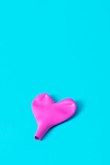 deflated pink heart-shaped balloon