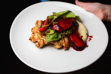 Turkey fillet with berry sauce in white plate