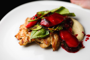 Turkey fillet with berry sauce in white plate