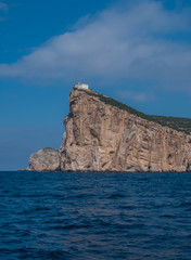 Fototapeta na wymiar Capo Caccia, a rocky outcrop set in a protected ecosystem near the town of Alghero, Sardinia, Italy. featuring. Scenic hiking routes, diving sites & caverns with archaeological remains