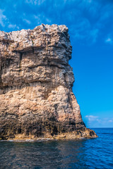 Fototapeta na wymiar Capo Caccia, a rocky outcrop set in a protected ecosystem near the town of Alghero, Sardinia, Italy. featuring. Scenic hiking routes, diving sites & caverns with archaeological remains
