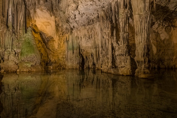 Neptune's Grotto (Grotta di Nettuno) a natural stalactite cave near Alghero , Sardinia, Italy. Accessible when the waters are calm by a steep stairway cut into the cliff or by boat from Alghero..