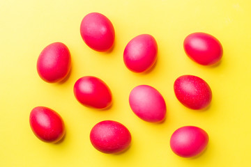 Colorful Easter eggs on yellow background. Copy space.