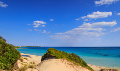 Summer seascape, Apulia coast: Marina di Lizzano beach (Taranto). The coastline is characterized by a alternation of sandy coves and jagged cliffs overlooking a truly clear and crystalline sea.