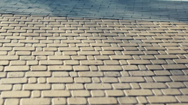 Park path made of stone. Walk and rest in the city. City life. Morning running. Movement on the track. Spring sunny day in nature