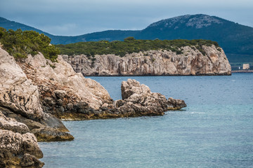 Fototapeta na wymiar Capo Caccia nature reserve, a rocky outcrop set in a protected ecosystem near the town of Alghero, Sardinia, Italy. featuring. Scenic hiking routes, diving sites & caverns with archaeological remains