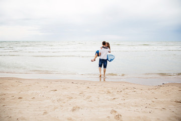 Young happy couple having fun on the beach..