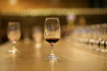 A glass of red wine is on the table